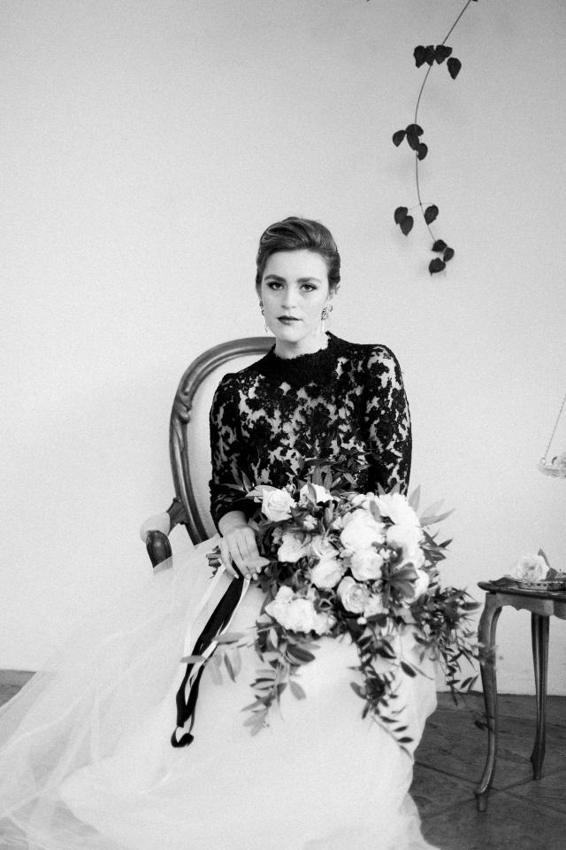 Black & White Closeup of Lady Sitting on Chair with Bouquet In Hands for Spanish Nights