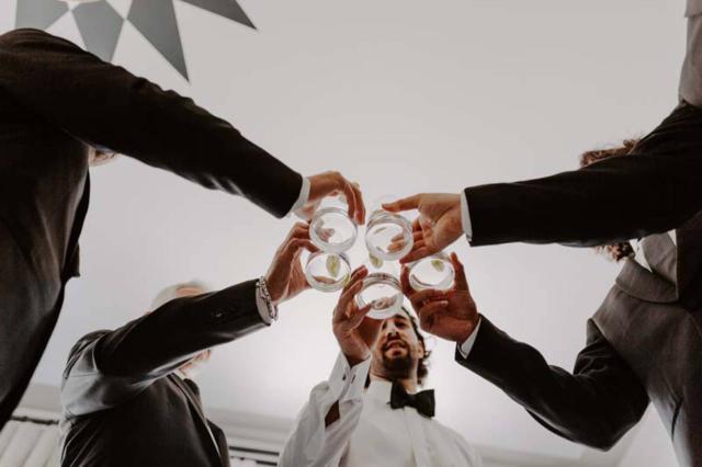 Below View of Groomsmen Clinking Glasses at Becky & Michael's Wedding