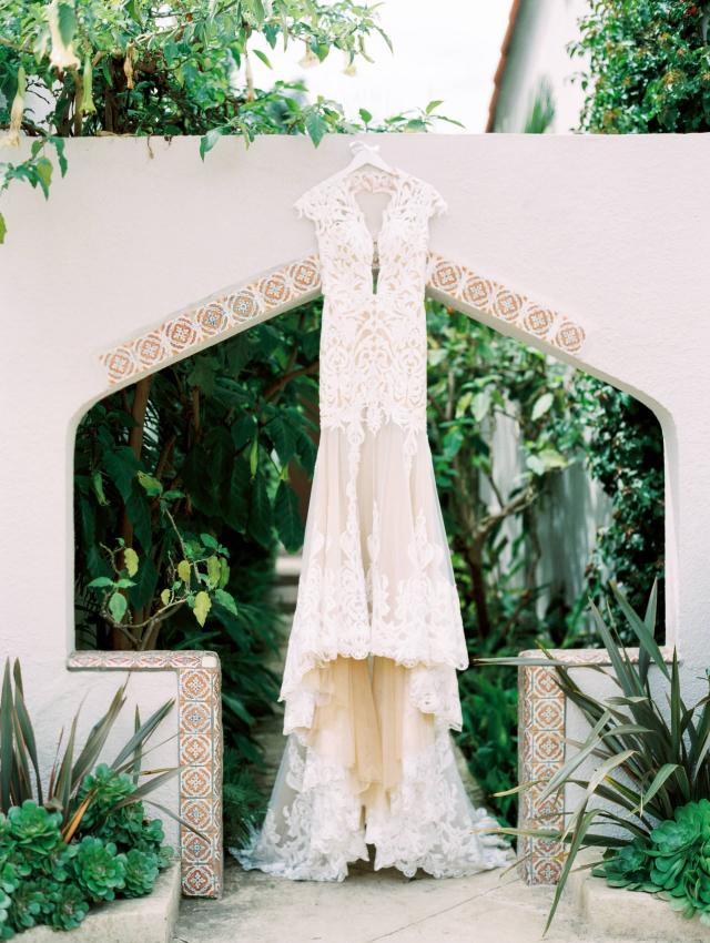 Wedding Dress Hanging on Outside Archway at Carly & Ben's Wedding