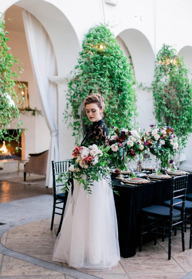 Lady Holding Flowers in Front of Table for Spanish Nights
