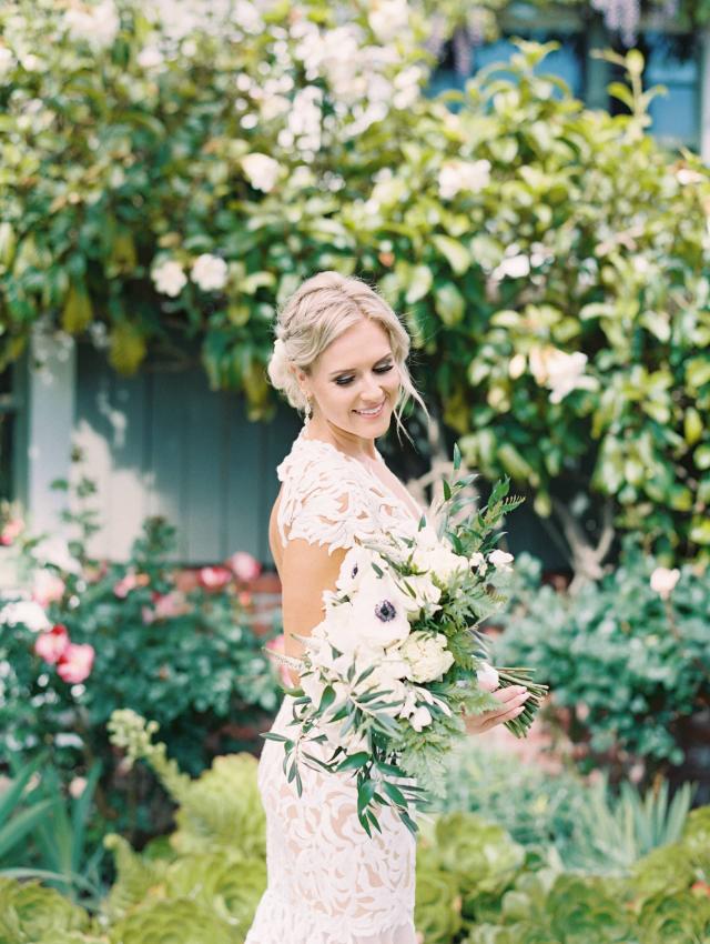 Bride Holding Flowers in Garden at Carly & Ben's Wedding
