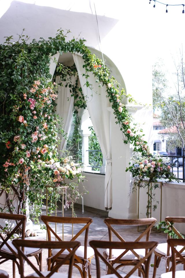 Medium View of Vine Flower Arrangement with Chairs at Rhiannon & Joshua's Wedding