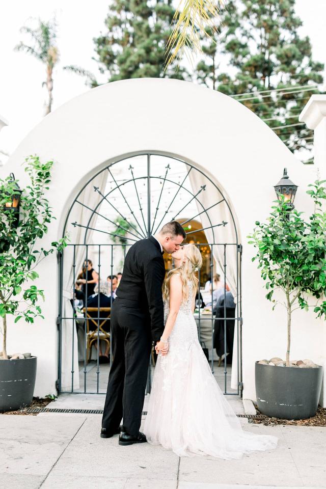 Bride & Groom Kissing at the Entrance at Stephanie & Grant's Wedding