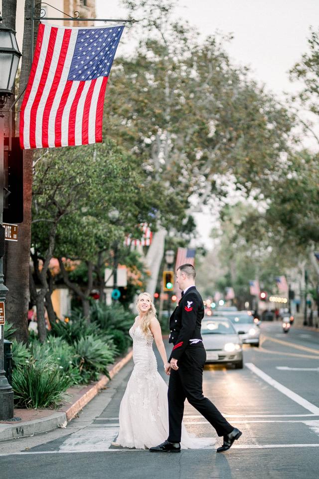 Bride & Groom Crossing the Road Under the USA Flag at Stephanie & Grant's Wedding