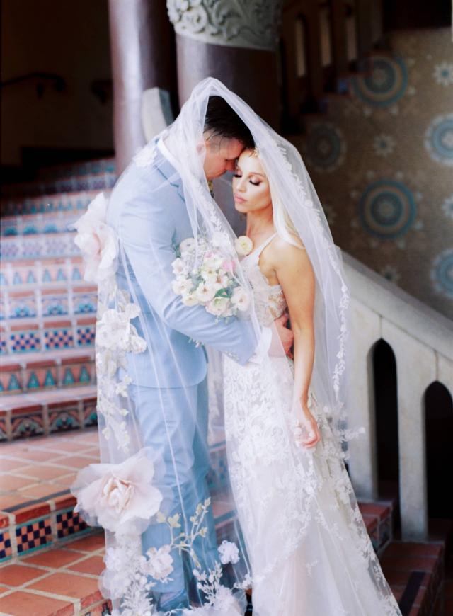 Bride & Groom on Stairs Wrapped in Bridal Veil at Rhiannon & Joshua's Wedding