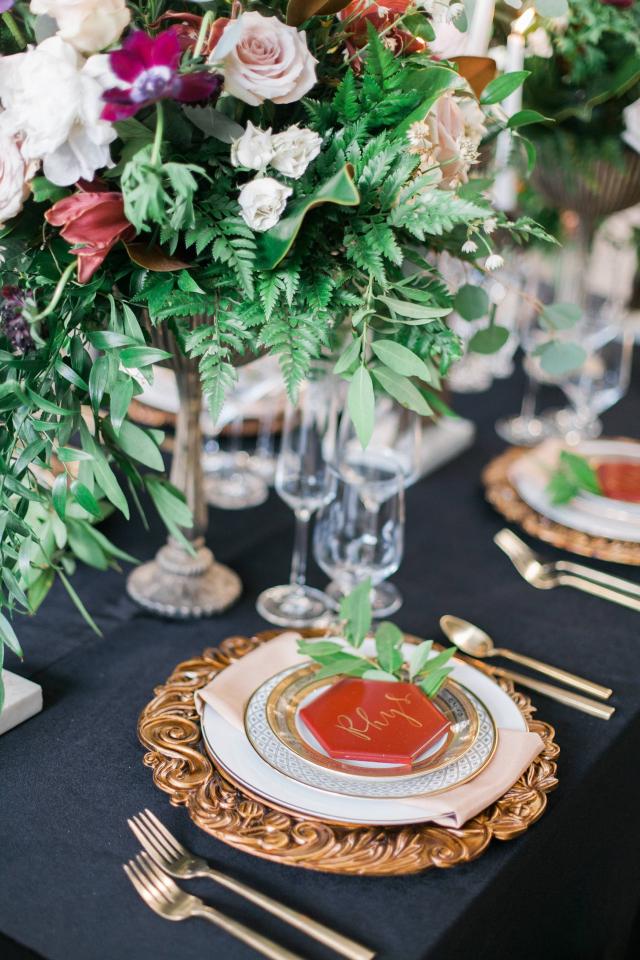 Closeup of Table with Flowers, Gold Plates & Cutlery, Flowers & Candles with Placemat for Spanish Nights 