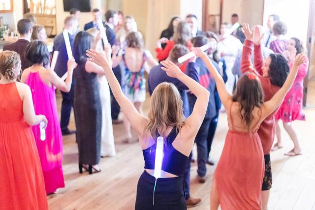 Guests Standing on Dance Floor with Fluorescent Lights at Angela & Kevin's Wedding