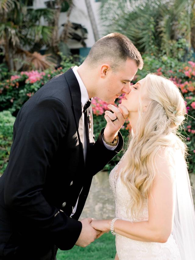 Bride & Groom Kissing in Front of Garden at Stephanie & Grant's Wedding