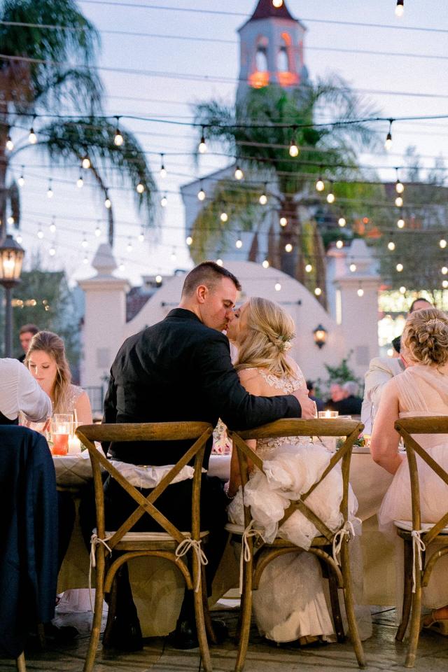 Bride & Groom Kissing at Table at Stephanie & Grant's Wedding