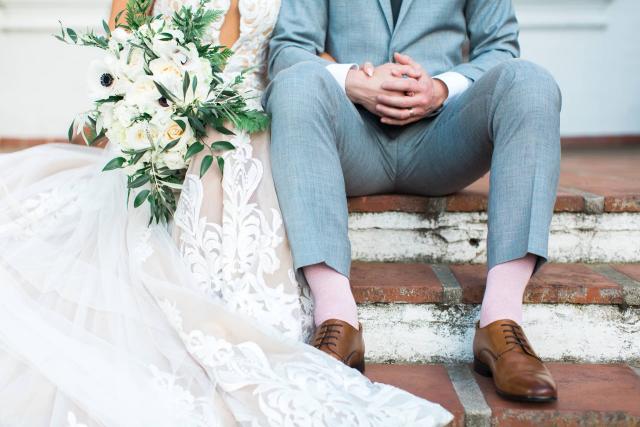 Bride & Groom Sitting with Flowers at Carly & Ben's Wedding
