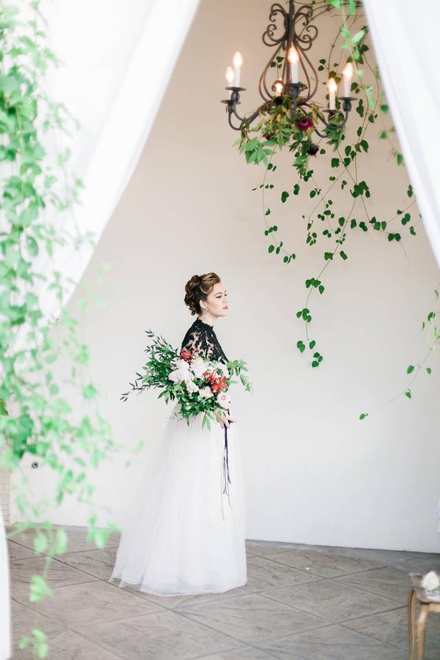 Lady Sideways Holding Flowers with Chandelier for Spanish Nights
