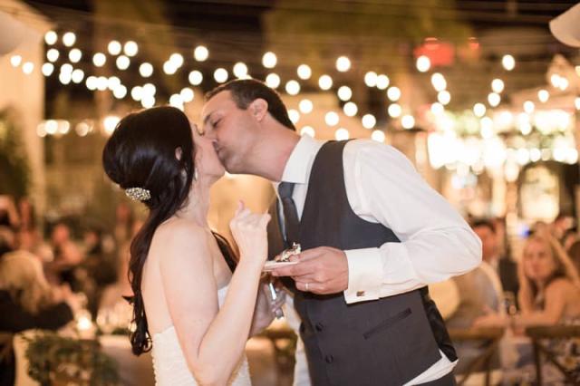 Bride & Groom Kissing after Eating Cake for Kelly & Jason’s Wedding
