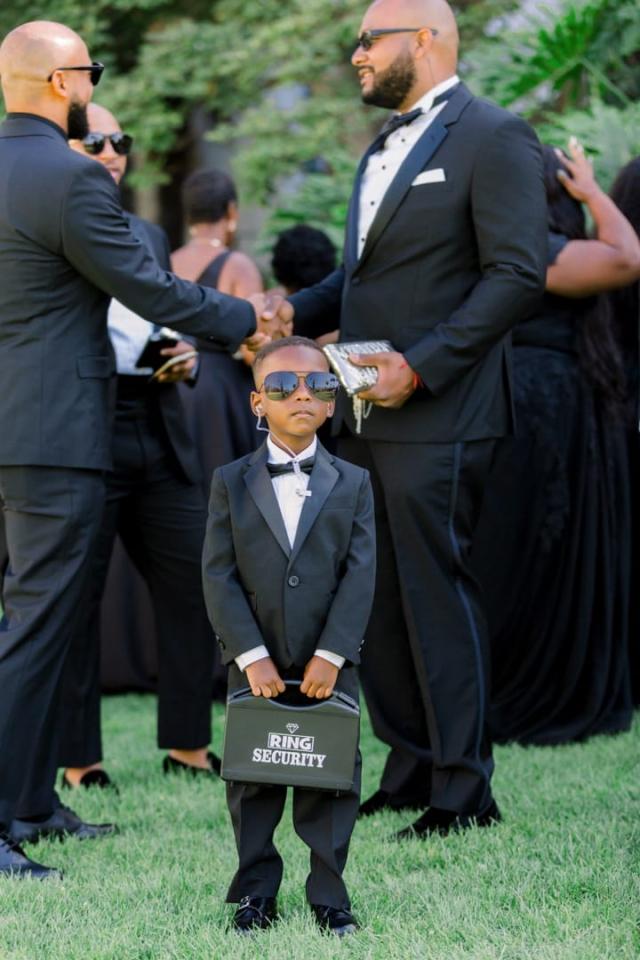 Young person dressed up like a security guard for Daniella & Karl's Wedding