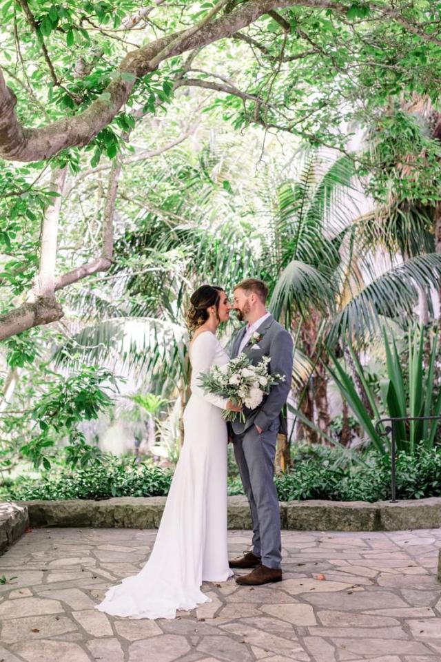 Couple embracing in front of trees for Danielle & Michael's Wedding