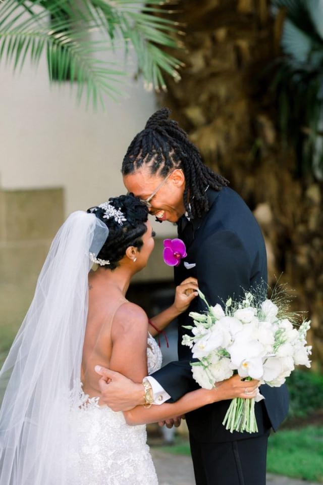 Husband and wife embracing on street for Daniella & Karl's Wedding