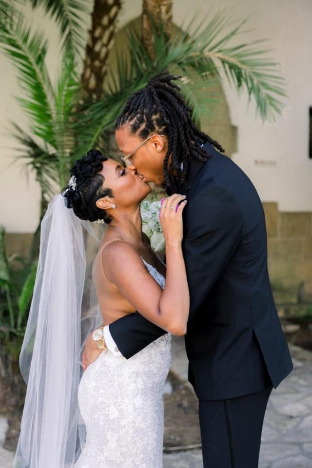 Husband and wife kissing on street for Daniella & Karl's Wedding