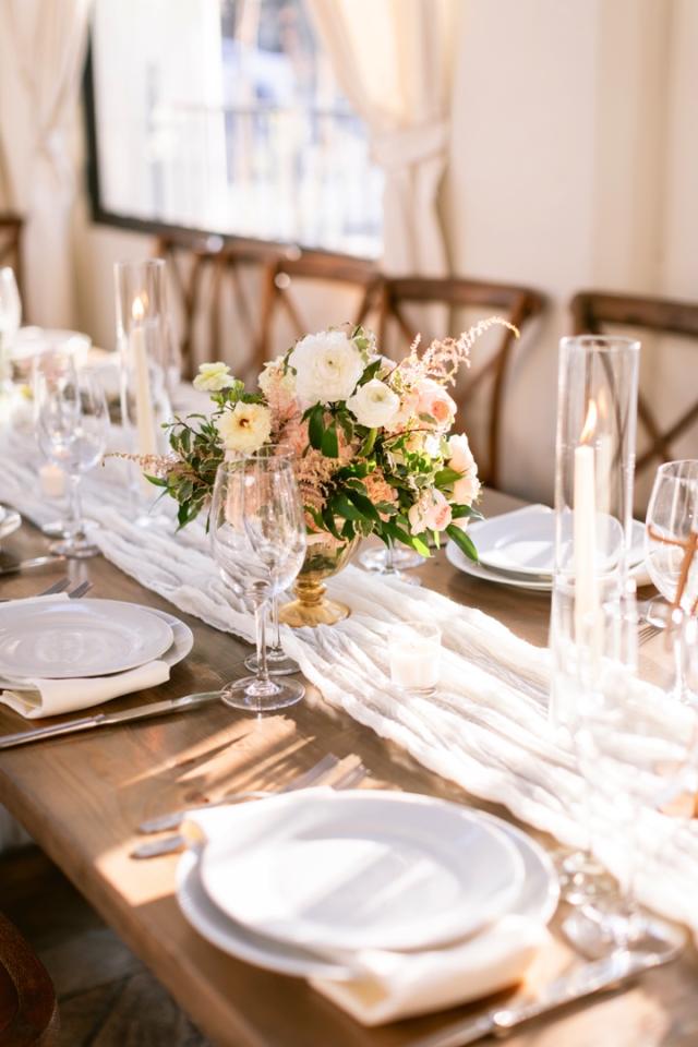 Wooden table with place sets and flower arrangement for Danielle & Richard's Wedding