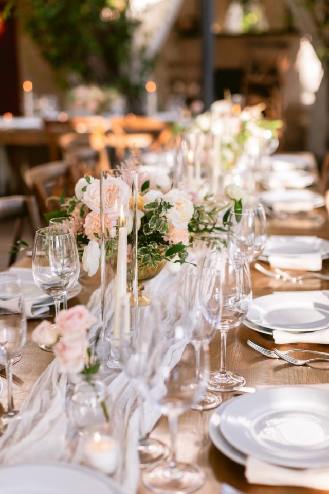 Long table view of place sets and flower arrangements for Danielle & Richard's Wedding