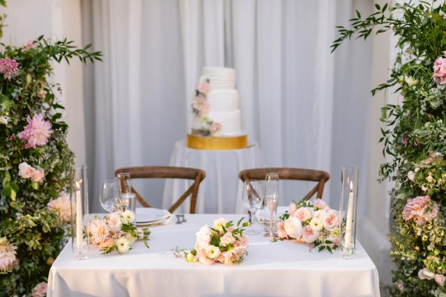 Bride and groom table with place sets and flowers for Danielle & Richard's Wedding