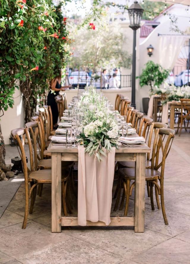 Full length wooden table with place sets for Danielle & Michael's Wedding