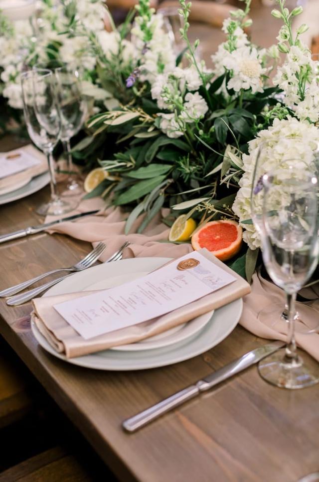 Complete table place set, including menu, cut citrus and flowers for Danielle & Michael's Wedding