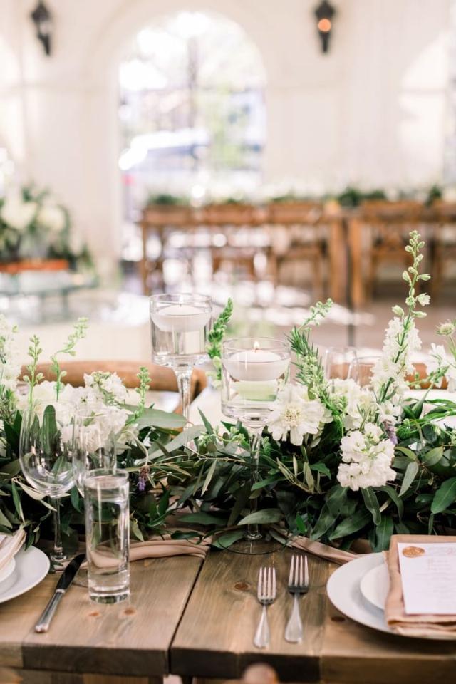 Flowers on wooden table with stain glass window in background for Danielle & Michael's Wedding