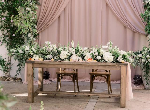Bride and groom wooden table with flower arrangement for Danielle & Michael's Wedding