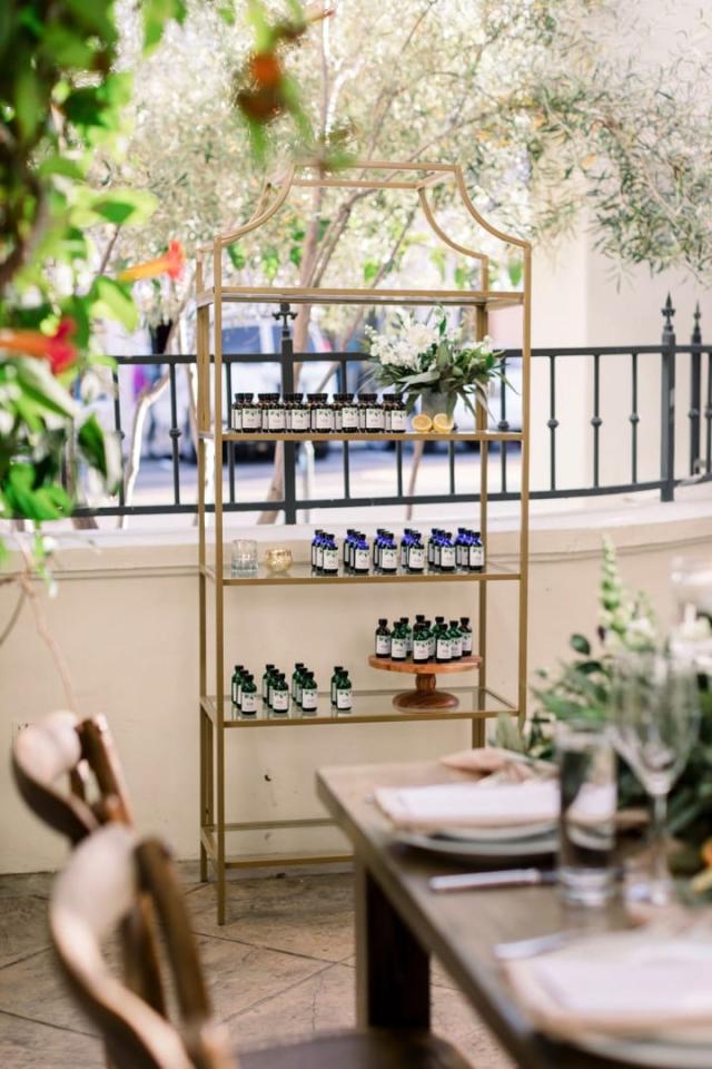 Display holding custom olive oil bottles for Danielle & Michael's Wedding