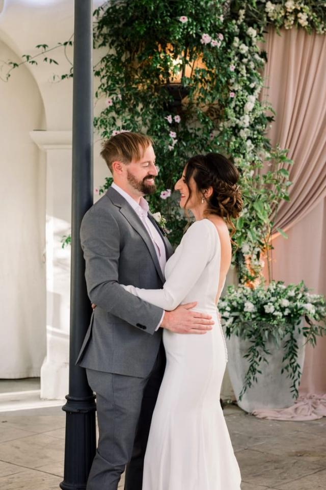 Bride and groom embracing next to lamp post for Danielle & Michael's Wedding