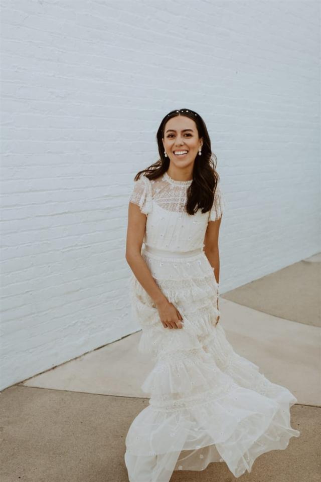 View of bride in front of white background for Paulina & Cam’s Wedding