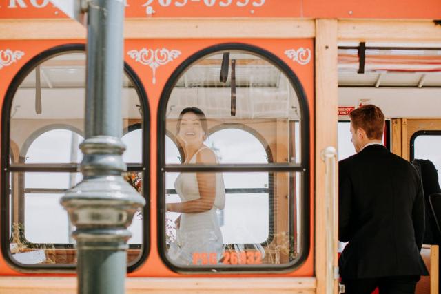 Bride and groom on tram for Veronica & Jake’s Wedding
