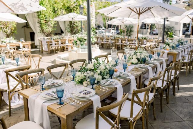 Full view of courtyard wedding tables and umbrellas for Sara & James’ Wedding