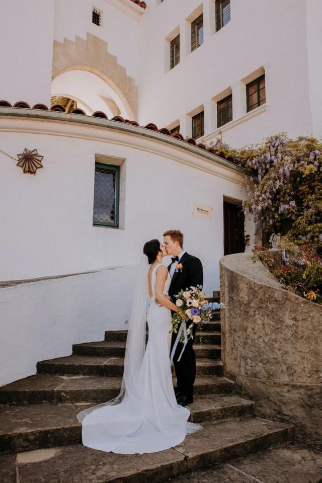 Bride and groom kissing on stairs for Veronica & Jake’s Wedding