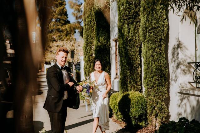 Candid shot of bride and groom on the street for Veronica & Jake’s Wedding