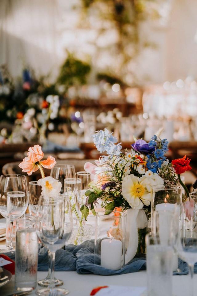 Close up of wedding table with glass, flowers and candles for Veronica & Jake’s Wedding