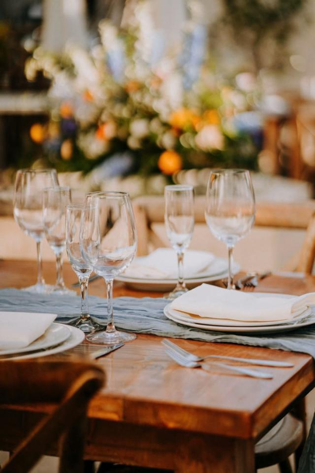 Close up shot of wooden table and place sets for Veronica & Jake’s Wedding