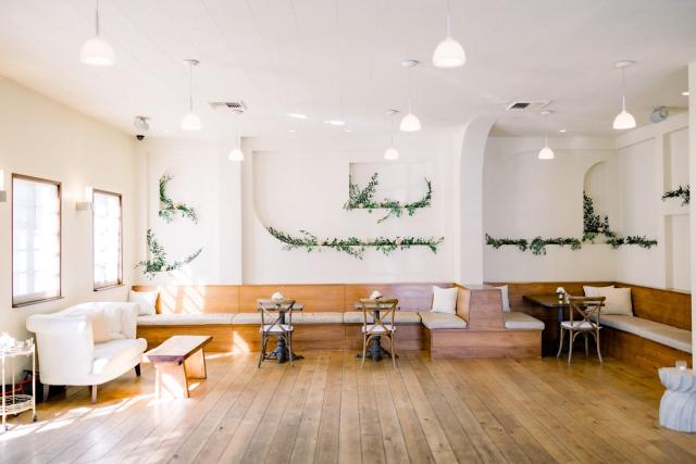 Internal room with empty wooden floor and areas for conversation for Sara & James’ Wedding