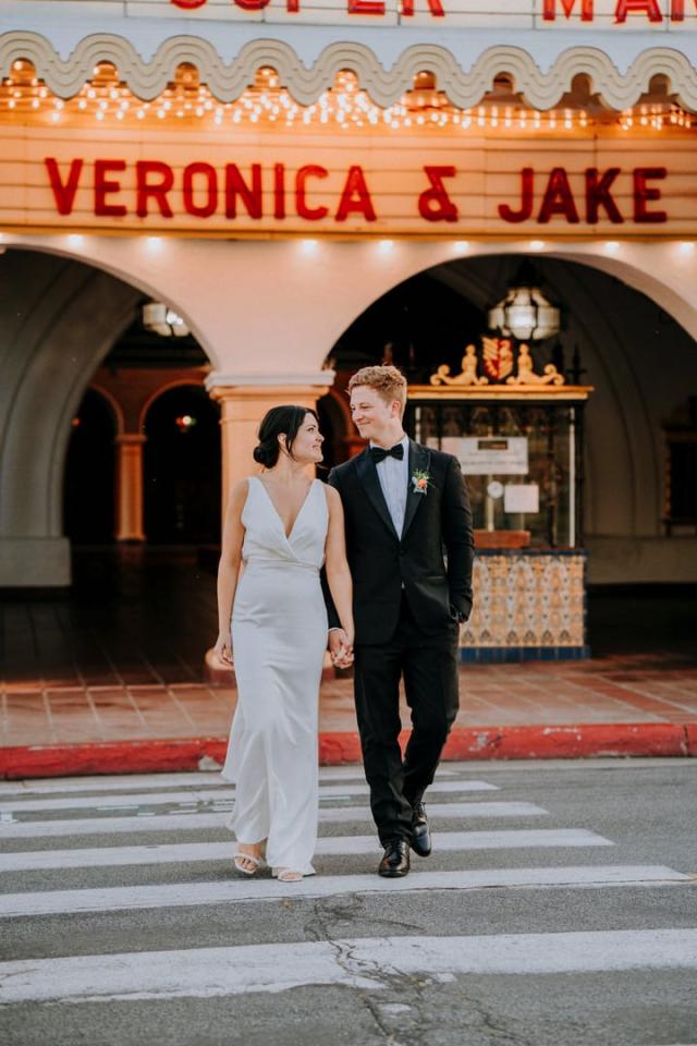Arlington Theatre sign of Veronica & Jake as they walk across the road for Veronica & Jake’s Wedding