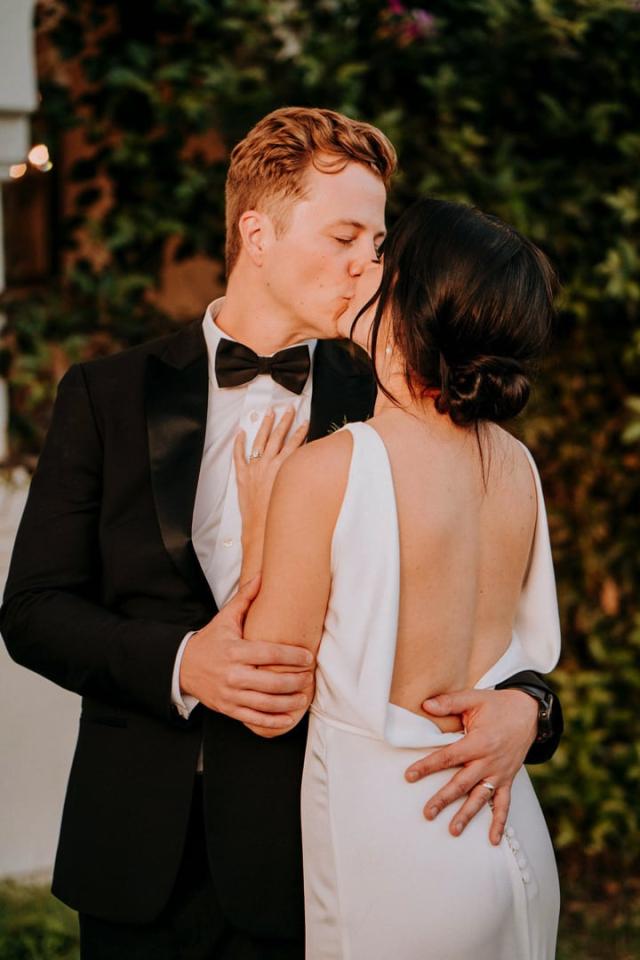 Bride and groom embrance as they kiss for Veronica & Jake’s Wedding