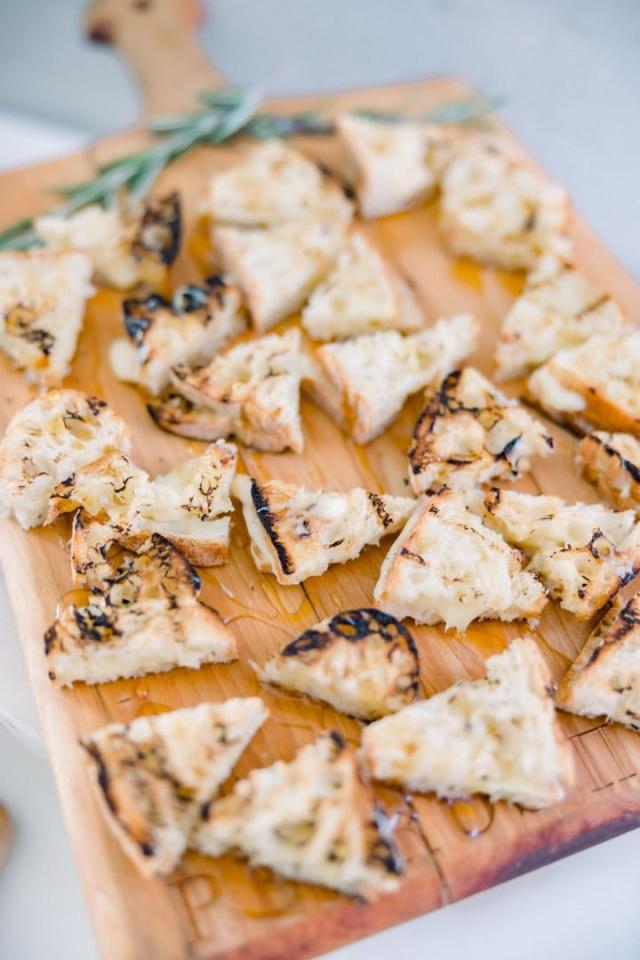 Side view of bread on wooden platter for Sara & James’ Wedding