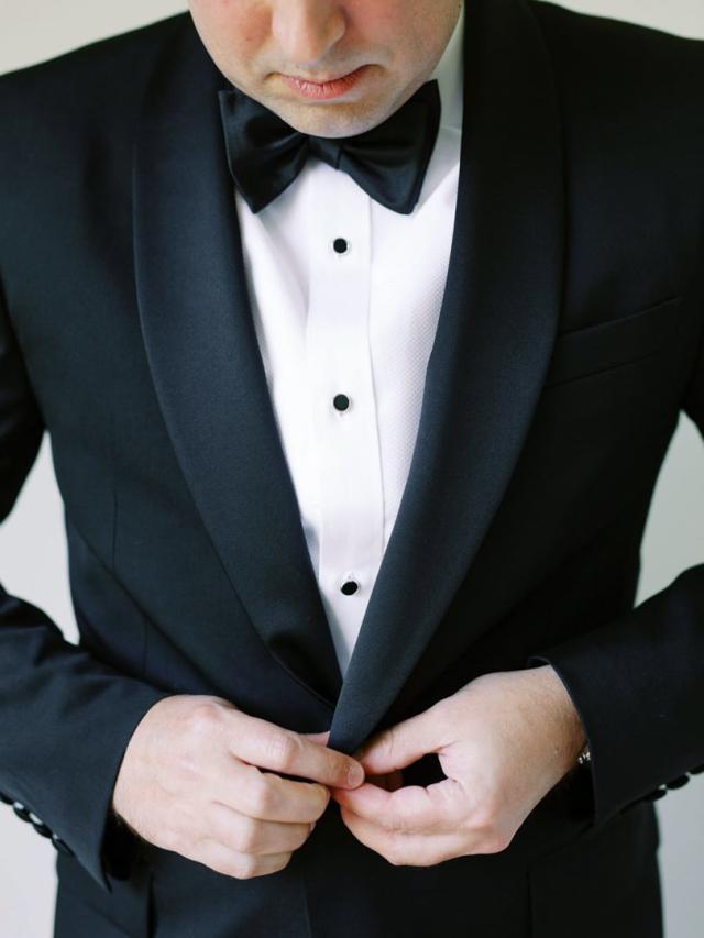 Groom buttoning his jacket for Jammie & Duncan's Wedding