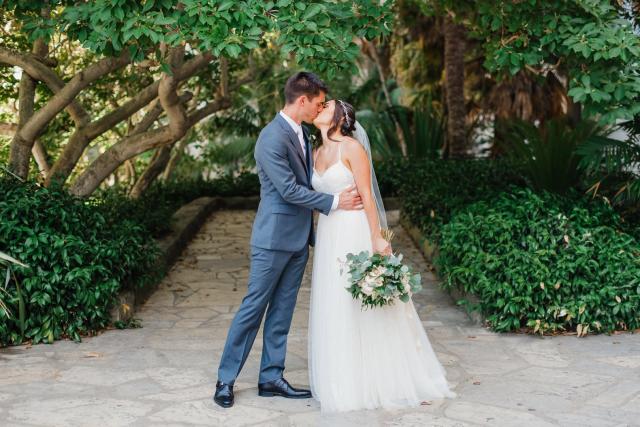 Bride and groom kissing on a path for Jennifer & Lars' Wedding