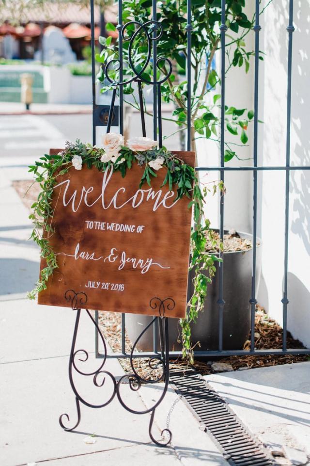 Wedding welcome sign with flowers on it for Jennifer & Lars' Wedding