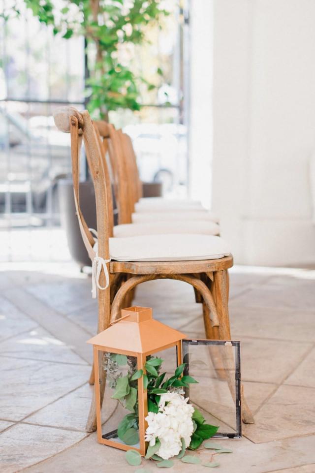 Line of chairs with a lantern and a picture frame for Jennifer & Lars' Wedding