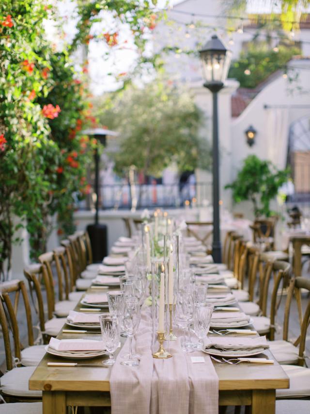 Long view of wedding table with placemats, flowers and candles for Jammie & Duncan's Wedding