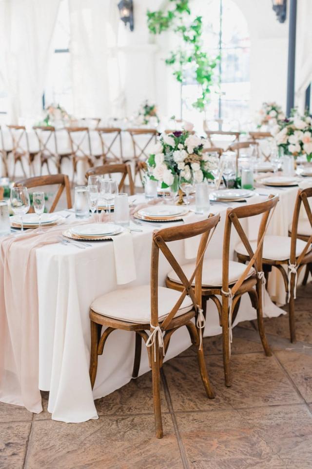 Cross shot of wedding table with placemats, flowers and chairs for Jennifer & Lars' Wedding