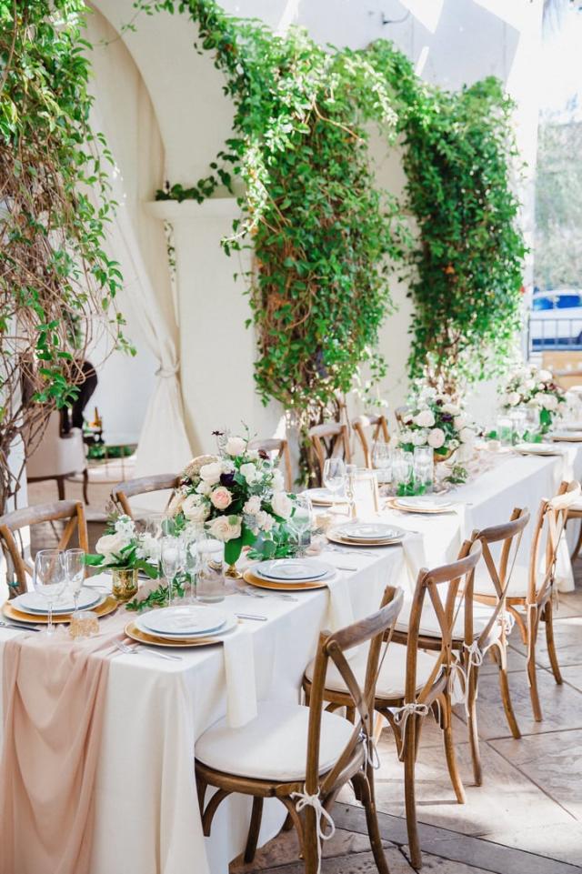 View of wedding table with placemats, flowers and chairs for Jennifer & Lars' Wedding