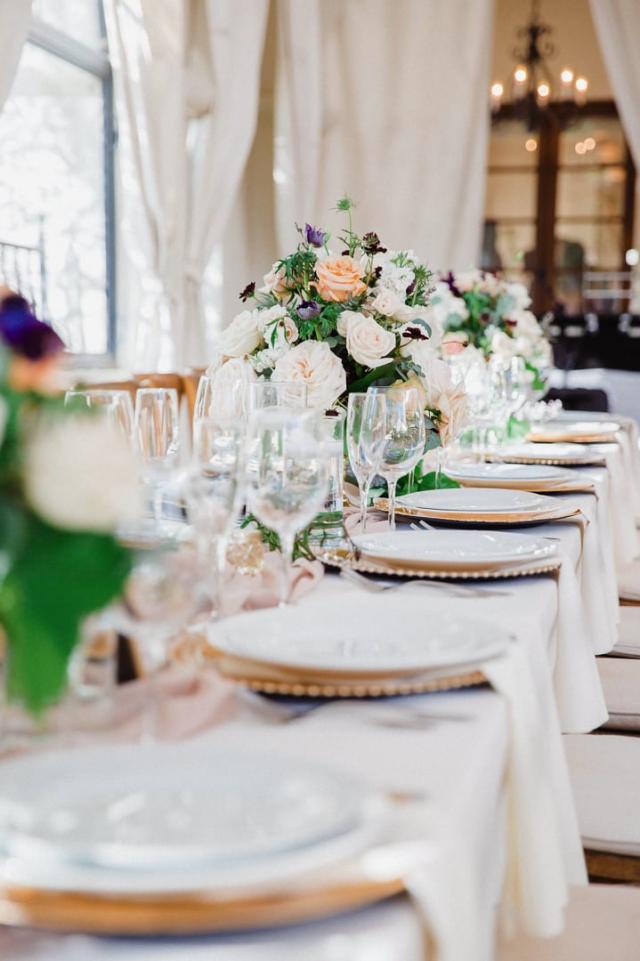 Wedding table set with white plates and flowers for Jennifer & Lars' Wedding