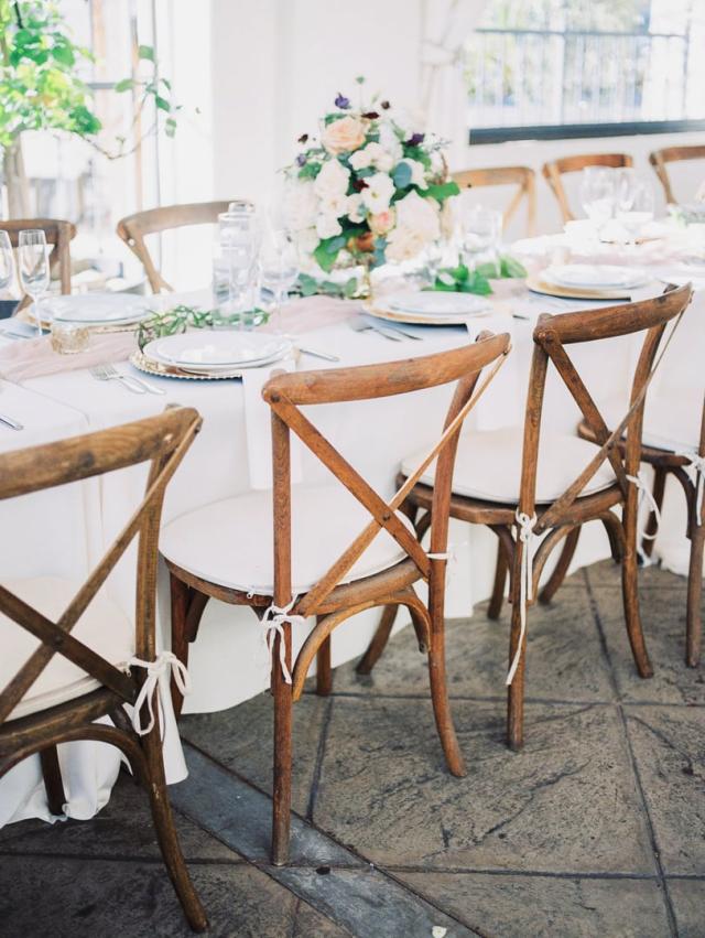 Mid shot of wedding table with placemats, flowers and chairs for Jennifer & Lars' Wedding