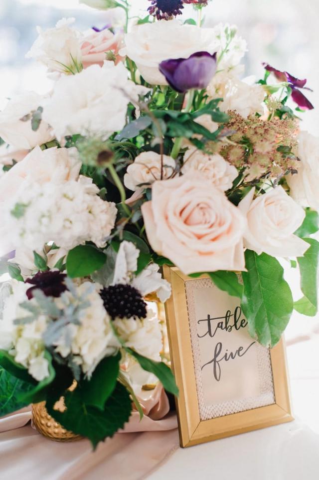 Colorful flower arrangement with table number for Jennifer & Lars' Wedding